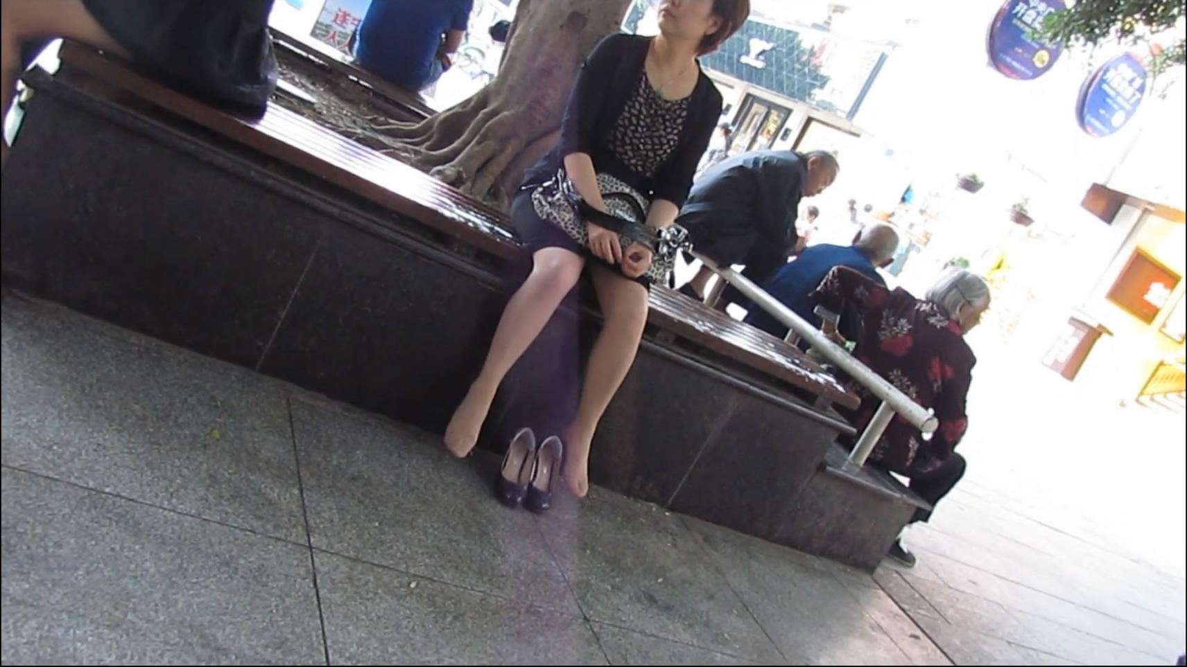 Playing Her Shoe and Feet in Public Space